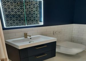 Floating vanity with LED backlit mirror and sleek basin in small Kingston bathroom renovation.