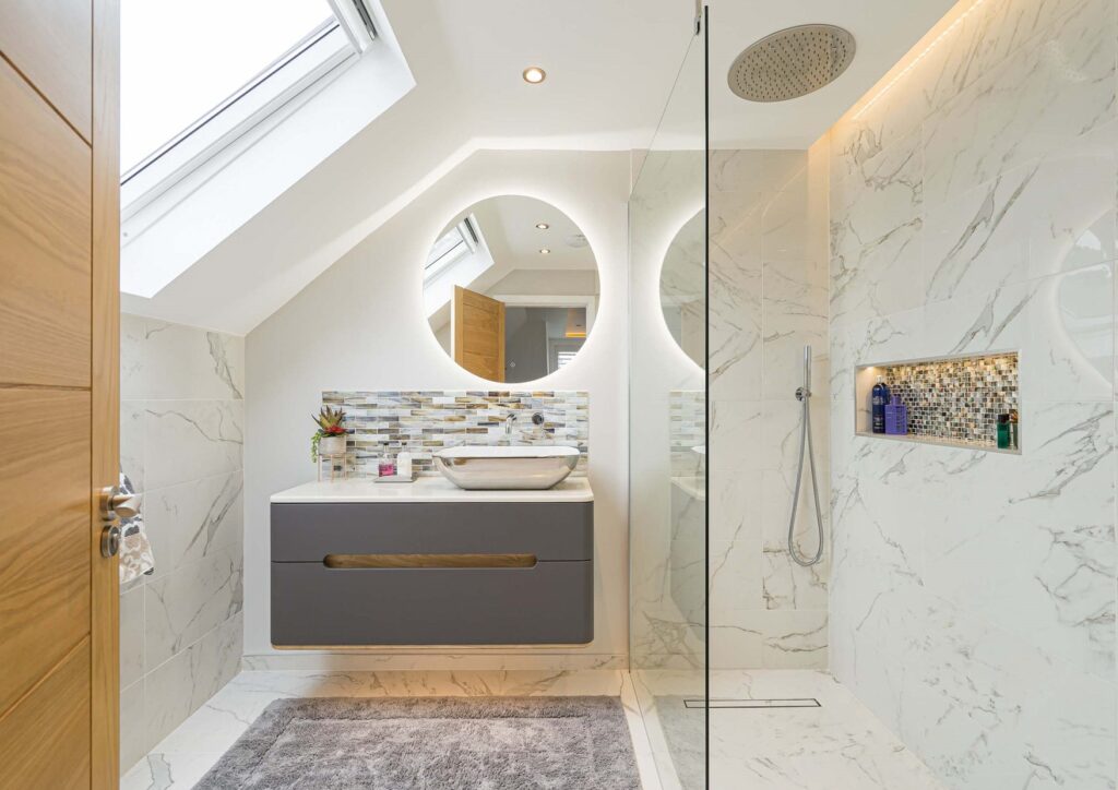 LED backlit mirror and small vanity unit in Kingston bathroom renovation.