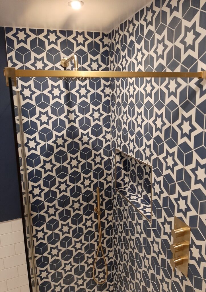 Patterned feature wall in small Surrey bathroom remodel showcasing bold design and elegant finishes.