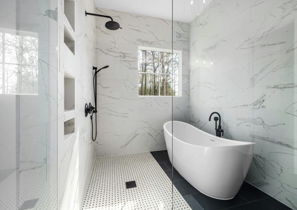 Modern small bathroom renovation in Kingston upon Thames with walk-in shower, floating vanity, and marble tiles designed by expert bathroom fitters.